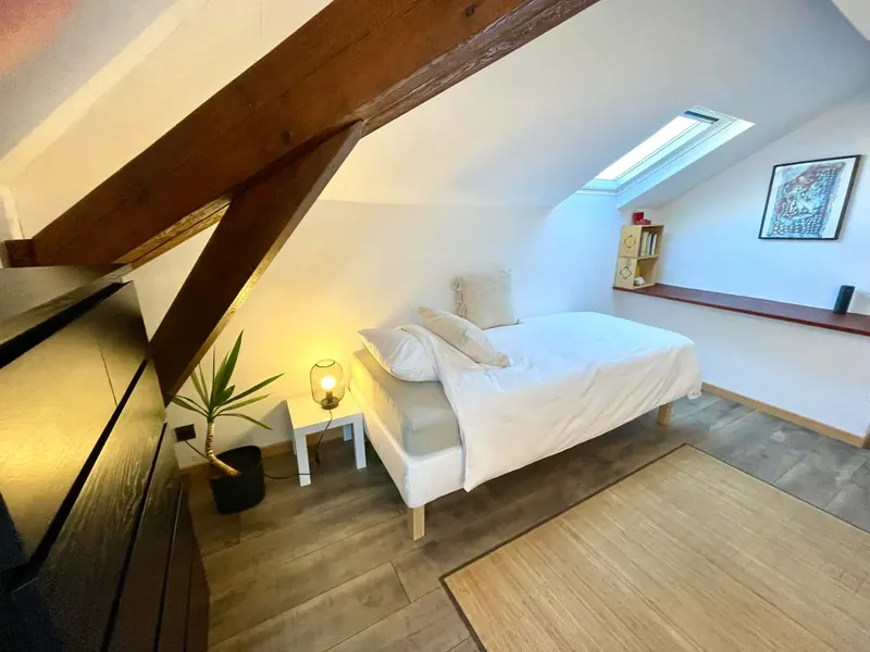 Bedroom 1 with beams, skylight and a bed that splits into two singles